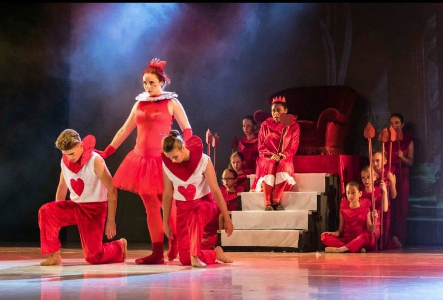 Ensemble en costumes rouges sur scène